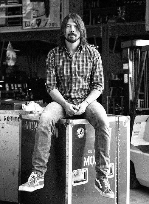 a man sitting on top of a metal box