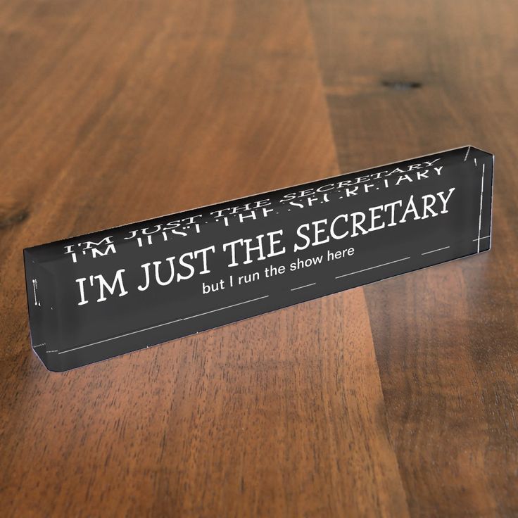 a sign that says i'm just the secretary but i run the show here