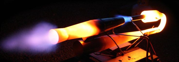 a close up of an electronic device on a table with fire coming out of it