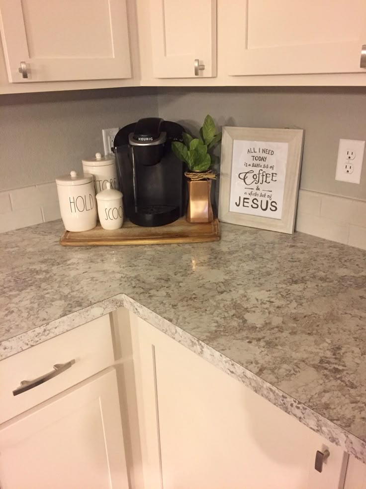 a counter top with some items on it in a kitchen next to white cupboards