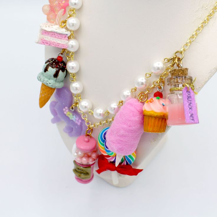 This kawaii statement necklace is called Pink Candy Shop and is a perfect cute charm jewelry gift for any woman in your life including your best friend (or yourself, let's be honest). This piece has been handmade from resin, clay and high quality metal components and features hand painted charms for a quality piece that will be a cute go-to in any charm lovers jewelry collection! Details & Measurements:-Handmade Necklace-High quality glass pearls-Hand-painted charms made from resin & polymer clay-Gumball machine has free floating beads inside! (note it is partially made from glass and fragile)-Choose Gold or Silver Finish -Choose 5, 7 or 9 charms (see list below to find out what charms come on each option)-Charms are chunky and are 1-2" in size (2.5-5cm)-19" (47.5cm) total Necklace Length- Handmade Dangle Charm Necklaces For Birthdays, Whimsical Charms Jewelry For Birthday, Whimsical Charms Necklace For Birthday, Whimsical Charms Necklace For Birthdays, Whimsical Birthday Jewelry With Charms, Whimsical Charm Jewelry For Birthdays, Kawaii Charms Jewelry For Gift, Whimsical Charm Necklaces For Birthday, Whimsical Charm Necklace For Birthday