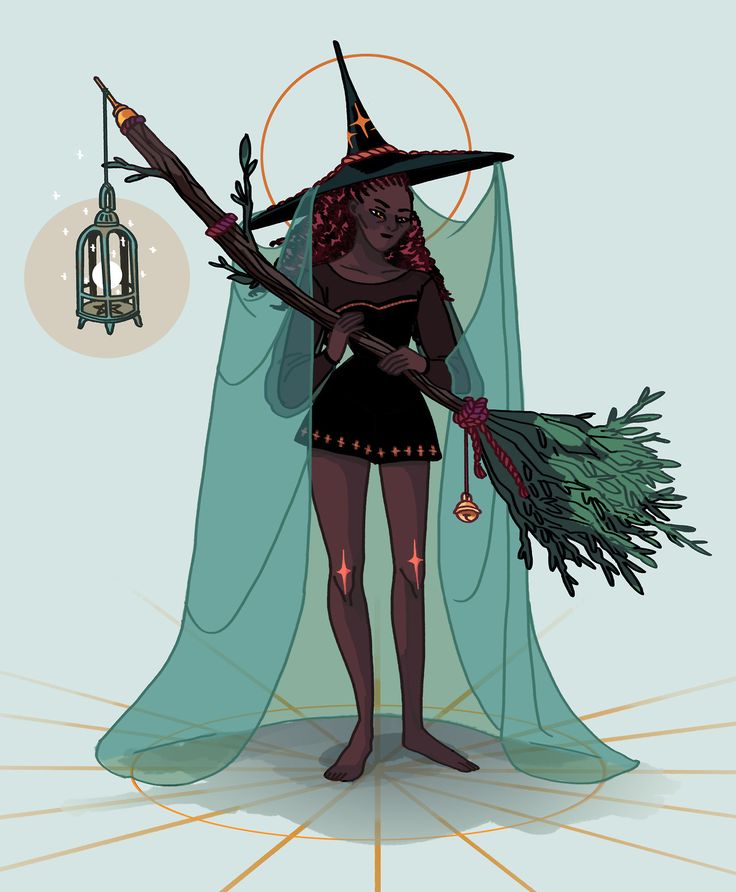 a woman dressed as a witch holding a broom