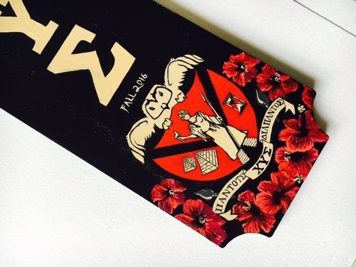 a black and red sticker with flowers on it