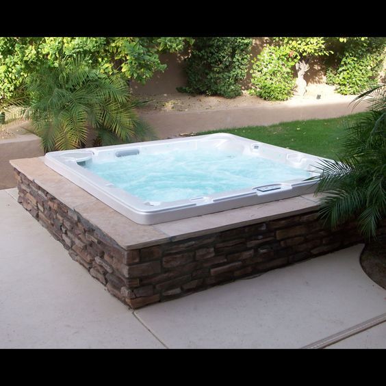 a hot tub sitting on top of a patio