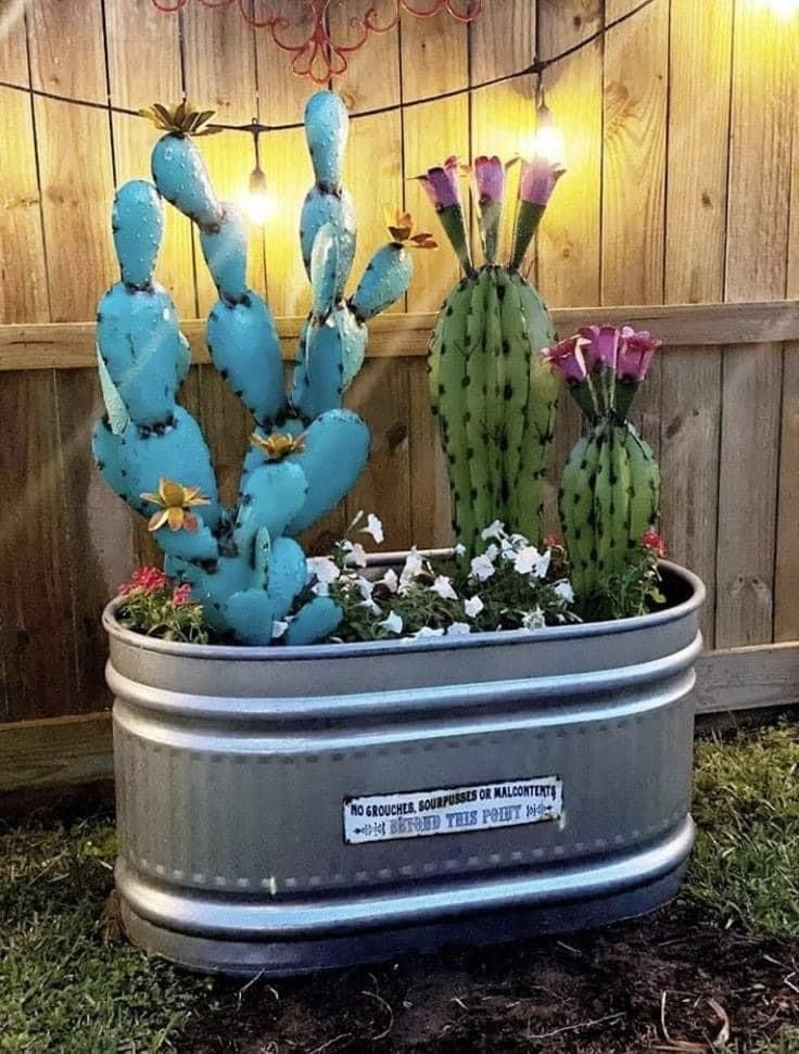 there is a potted cactus with flowers in it