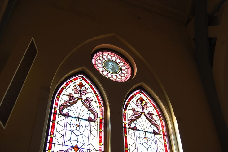 two large stained glass windows in a church