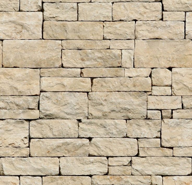 a stone wall that has been made out of several different types of stones and is beige