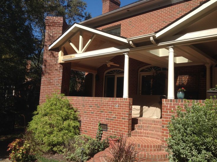 a brick house with white columns and an awning