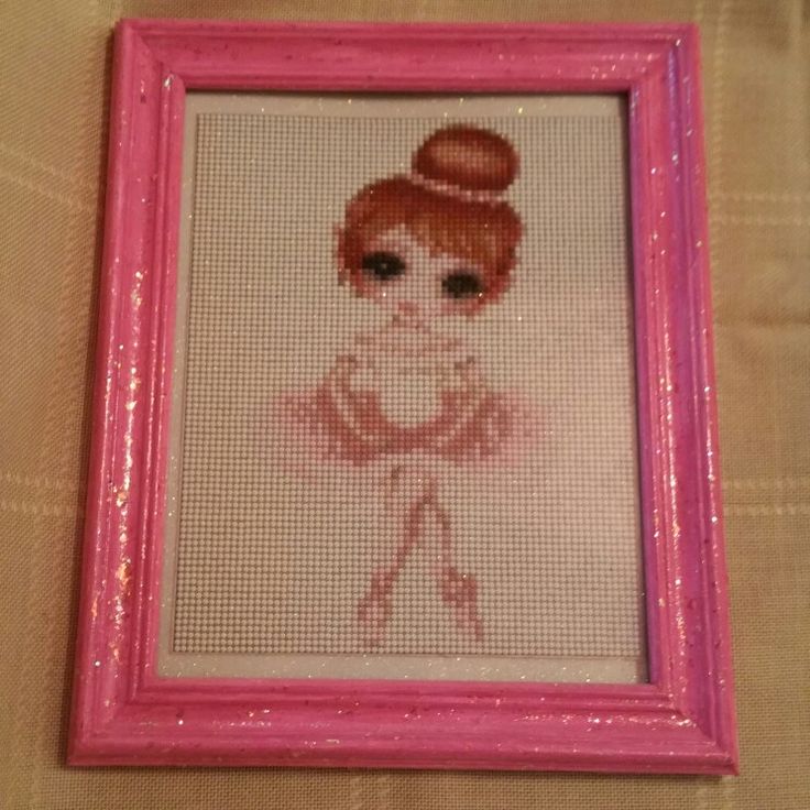 a cross stitch picture in a pink frame