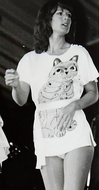 black and white photograph of woman in short shorts with cat t - shirt on her chest