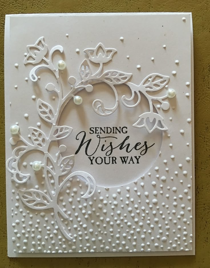 a white card with pearls on it that says sending wishes your way