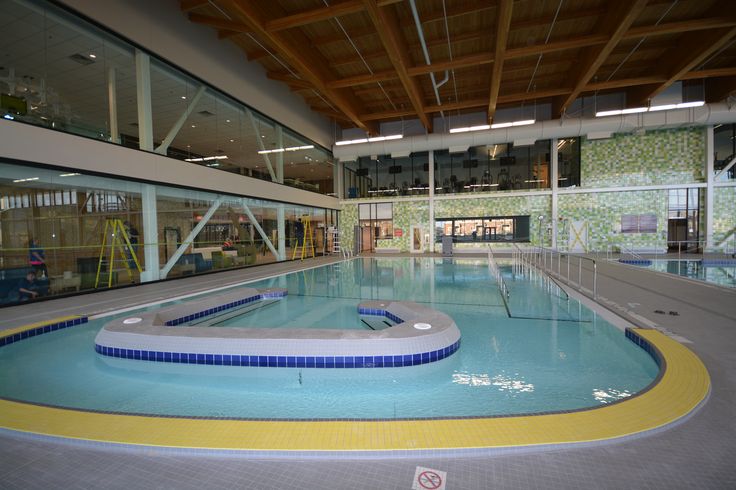 an indoor swimming pool in the middle of a building