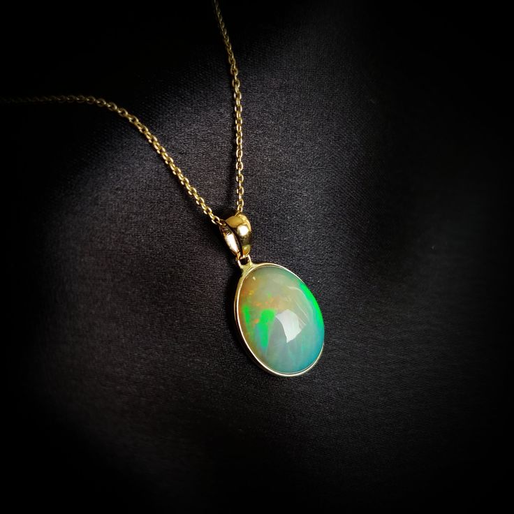 This stunning Pendant is set in 14k Solid Yellow Gold with Natural Ethiopion White Opal with utmost precision. It is a unique gemstone Pendant for nearly every occasion and is completely hassle-free jewelry. ITEM DETAILS: * GEM: White Opal * GEM SIZE: 12.5X15mm * GEM SHAPE: Oval * Gem weight: 4.03 carats * Gold Purity: 14KT  * Gold Weight: 0.55 gram * Total Weight of the Pendant: 1.34 gram The Gold purity is guaranteed and it comes with authentic 14KT gold hallmark. Since my items are handmade, Oval Yellow Gold Jewelry With High Luster, Oval Yellow Gold High Luster Jewelry, Oval Fine Jewelry With High Luster, Oval 14k Gold Jewelry With High Luster, Oval 14k Gold High Luster Jewelry, High Luster Oval Fine Jewelry, 14k Yellow Gold Gemstones For Gift, Hallmarked Yellow Gold Gemstones For Gift, High Luster Oval Gemstones For Gifts