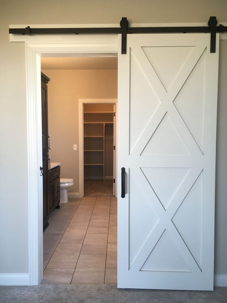 an open door leading to a bathroom with tile flooring