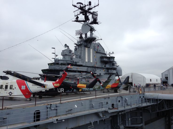 an aircraft carrier is parked on the deck of a ship