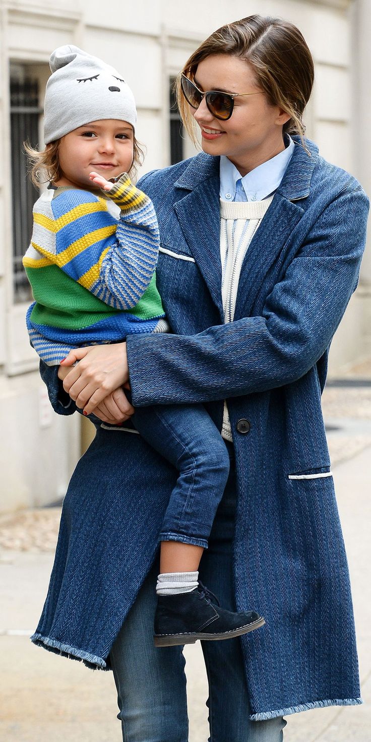 a woman holding a small child in her arms