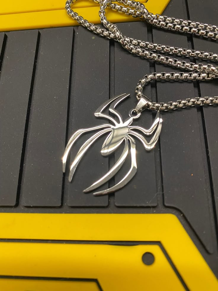 Spiderman Logo Pendant Made in metal alloy and polished. A chain is included Kindly note, due to their handmade nature, there may be minor imperfections on each piece. Ships from Singapore via registered post. You will be provided with the tracking number. Please check out our other listings with lots of cool swag. https://www.etsy.com/sg-en/shop/RancorRider?ref=seller-platform-mcnav Our Shipping policy. We will provide you with the tracking number once the item has been dispatched. Kindly be pa Spider Man Things To Buy, Masc Accessories, Spiderman Jewelry, Spiderman Necklace, Spiderman Accessories, Spiderman Stuff, Spider Logo, Spiderman Logo, Spiderman Gifts