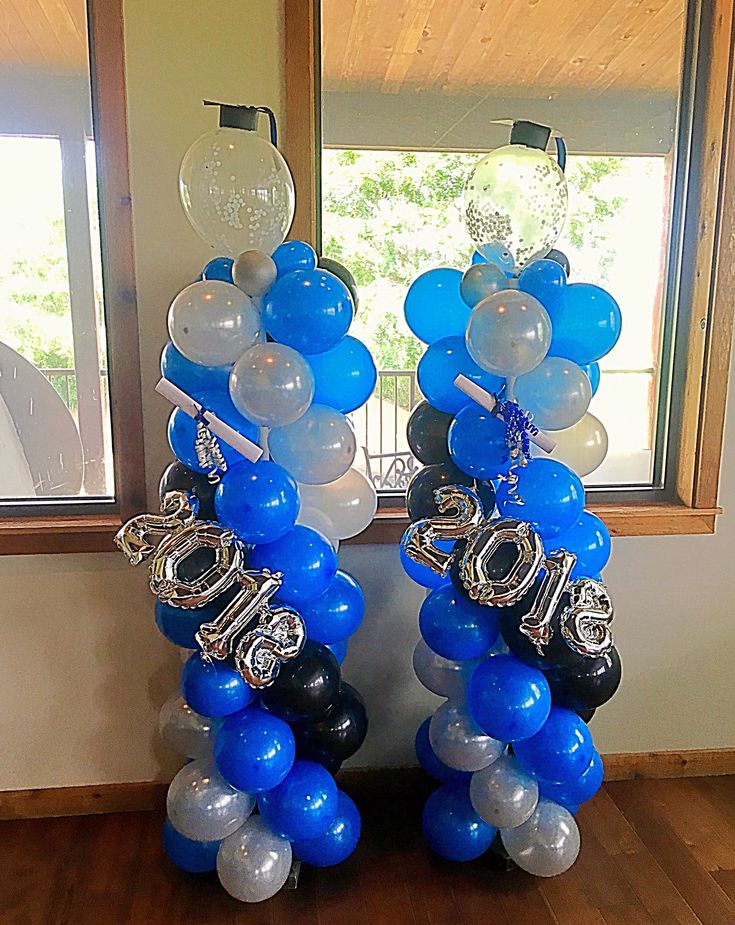 blue and white balloons are arranged in the shape of letters on top of each other