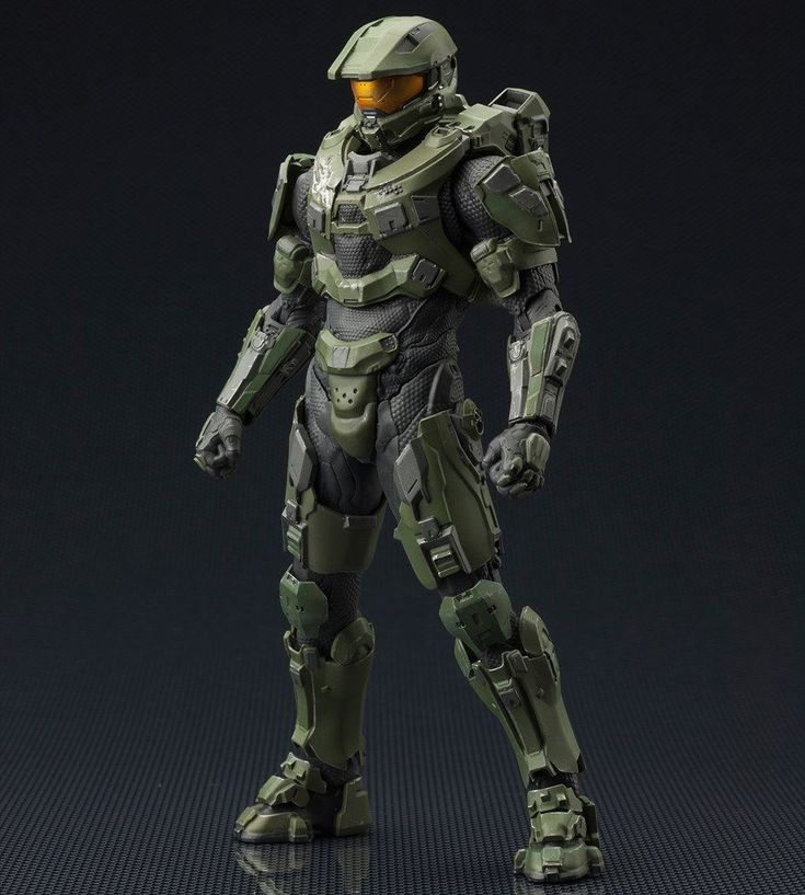 an action figure is posed on a dark background