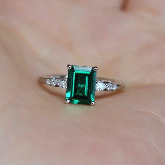 Breathtaking minimalist style green emerald ring, with a 1.2ct emerald in the middle, with a pear stone and two round stone on each side, simple but elegant design, can also wear with different bands, to make a unique match, beautiful and special gift for someone you loved or for yourself, we all worth beautiful items.Material: 925 sterling silver or solid 14K goldMain Stone: 6*8 mm Real Lab Created Emerald, about 1.3 ctCut: EmeraldSide Stone: CZBand Width: Approximately 1.6mmCS0365❥Custom Order Emerald Cut Emerald Ring With Vvs Clarity, Green Diamond Emerald Ring As A Gift, Green Emerald Diamond Ring As A Gift, Green Emerald Diamond Ring For Gift, Emerald Ring With Diamond For Gift, Green Emerald Ring As A Gift, Green Emerald Cut Birthstone Ring With Accent Stones, Green Vvs Clarity Rings For Proposal, Green Emerald Birthstone Ring