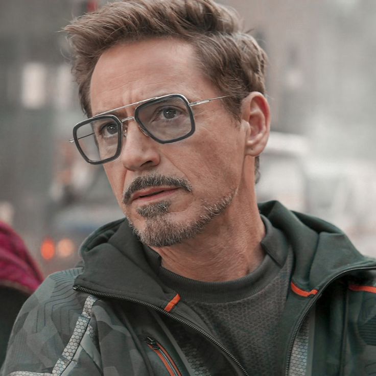 the avengers movie character is wearing glasses and looking off to the side with his head tilted