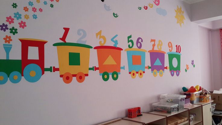 a child's room with a train painted on the wall