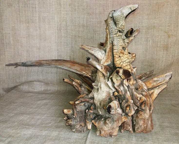 a piece of driftwood that has been turned into a sculpture on a table cloth