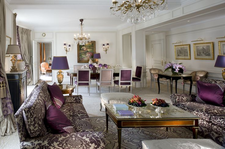 a living room filled with furniture and a chandelier