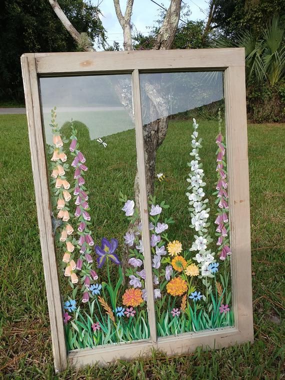 an old window with flowers painted on it