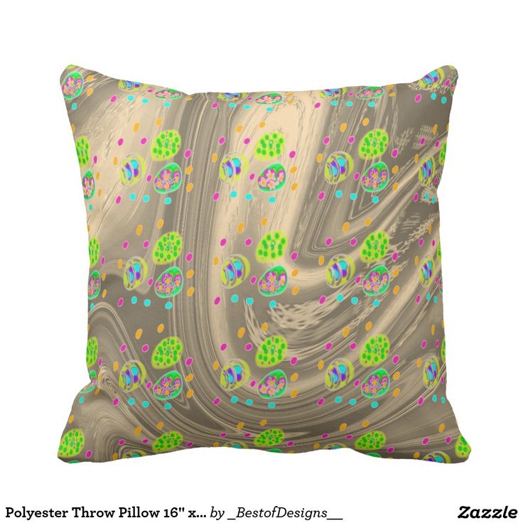 a pillow that is on top of a white surface with green, blue and pink designs