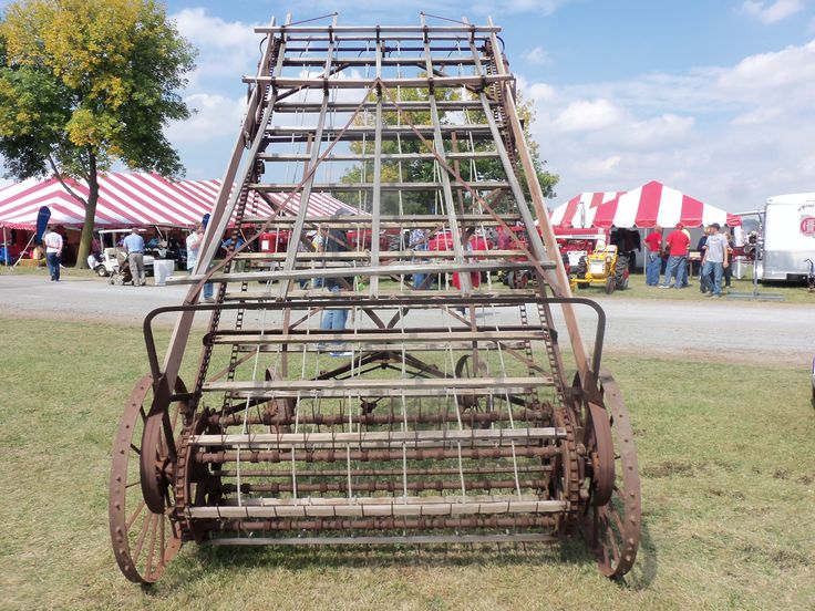 a large metal structure sitting in the middle of a field