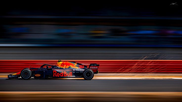 a red bull racing car speeding down the track