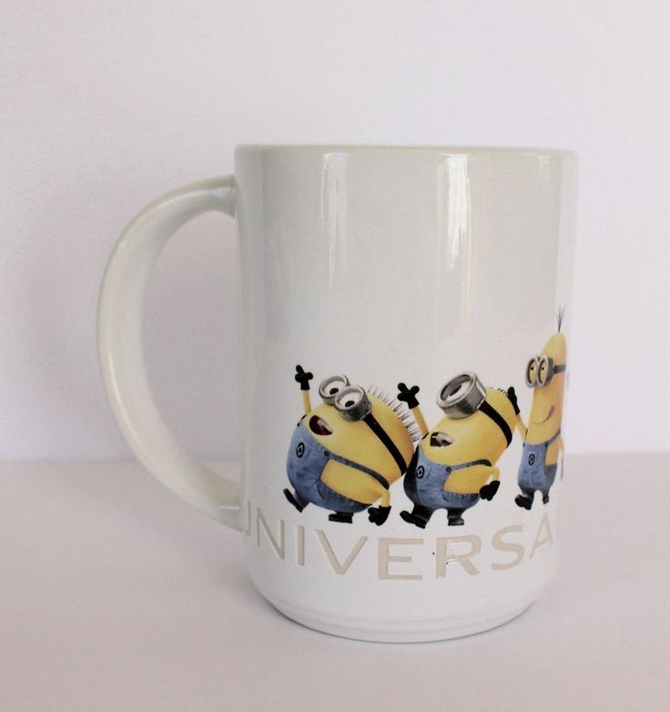 a white coffee mug with two minion characters on it