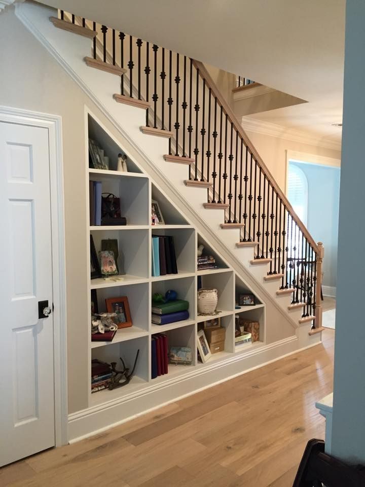 a room with a staircase and bookshelf in it