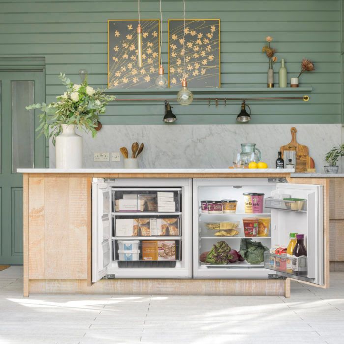 an open refrigerator in a kitchen next to a counter