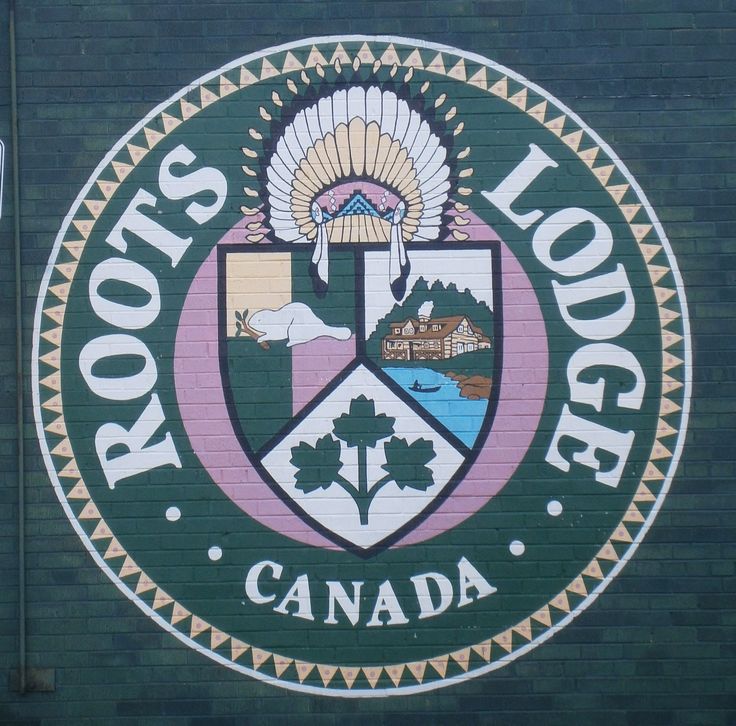 a sign on the side of a building that says roots lodge canada