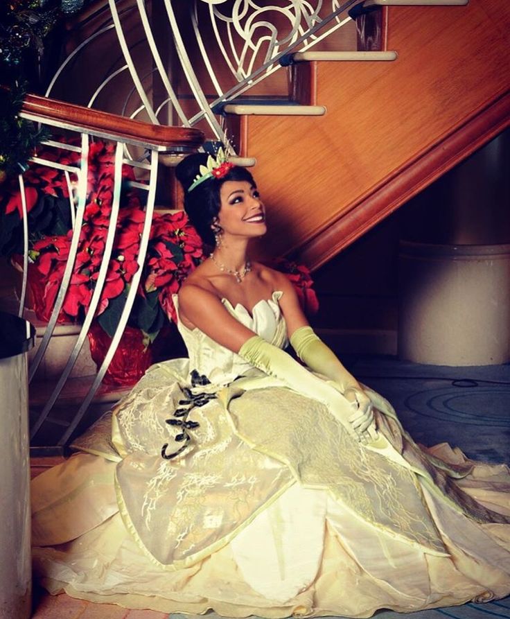 a woman in a white dress is sitting on the stairs