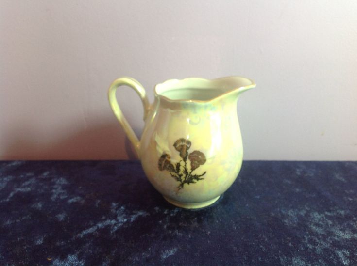 a yellow pitcher sitting on top of a blue table