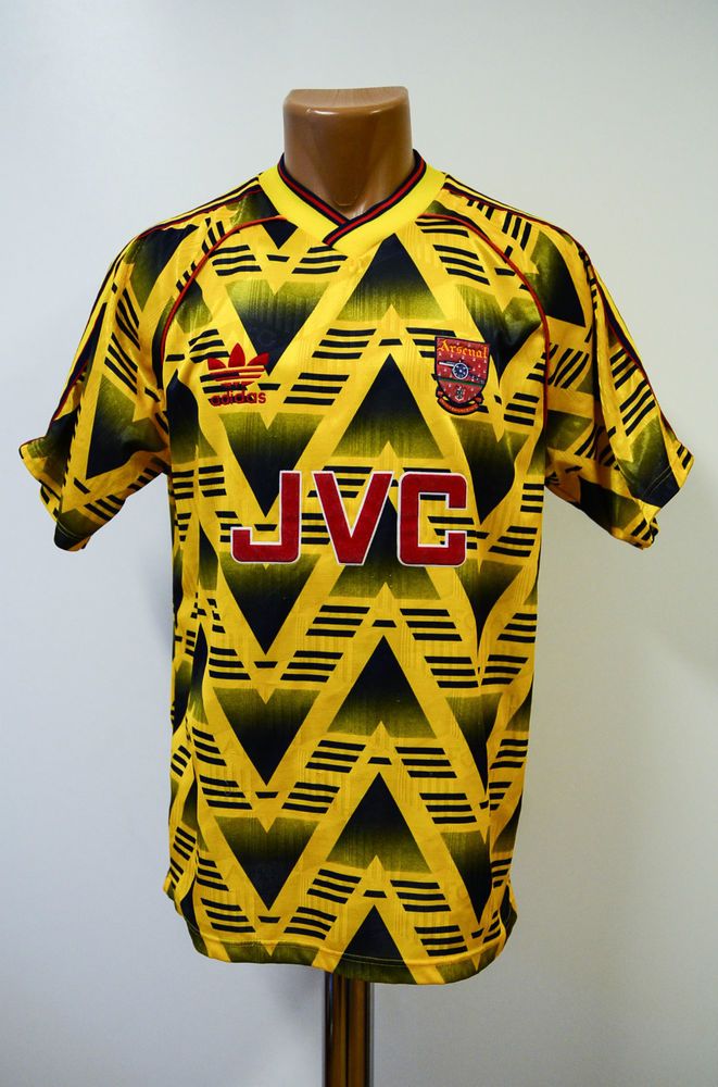 a yellow and black soccer jersey with the word jvg on it's chest