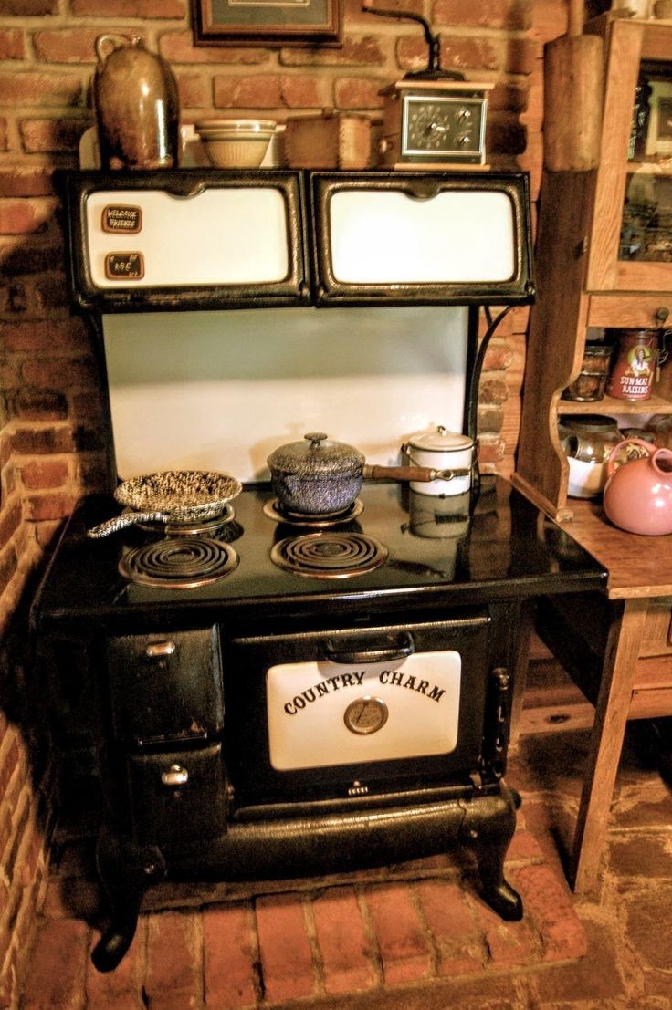 an old fashioned stove with pots and pans on it