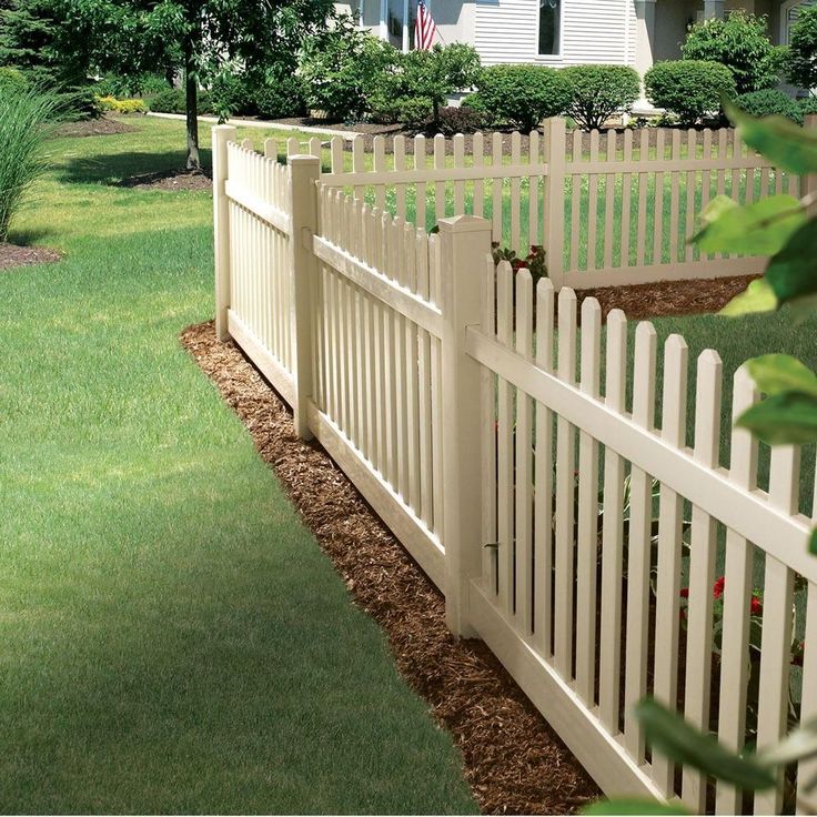 a white picket fence in front of a house