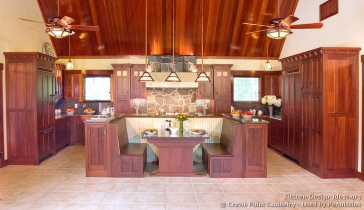 a large kitchen with wooden ceiling and tile flooring