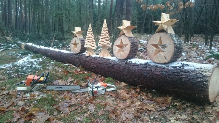 a log with christmas trees cut into it and chainsaws attached to the logs