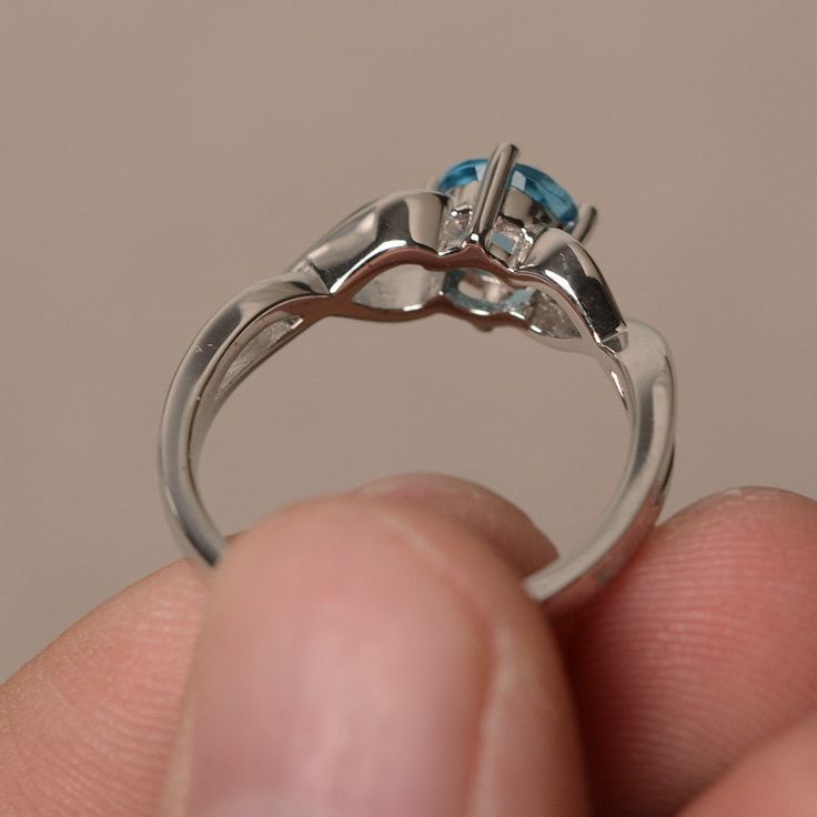 This is a gorgeous handmade creation. Its beauty is its simplicity & Elegance. The 6*6 mm round shape faceted real Swiss Blue Topaz is crafted in solid sterling silver and with rhodium plated. All item is sent in a beautiful gift box If you have any idea of design your ring,pls contact me directly. You can realize more lovely stuff clicking the link https://www.etsy.com/shop/knightjewelry?refshopsection_shophome_leftnav Please leave the correct address and you phone number for delivering suc Blue Topaz Solitaire Crystal Ring, Topaz Birthstone Ring For Promise With Round Cut, Blue Topaz Promise Rings With Birthstone Detail, Elegant Topaz Birthstone Ring For Promise, Promise Topaz Birthstone Ring, Sterling Silver Solitaire Topaz Promise Ring, Fine Jewelry Blue Topaz Ring With Round Stone, Fine Jewelry Blue Topaz Promise Ring, Promise Ring With Blue Topaz In White Gold