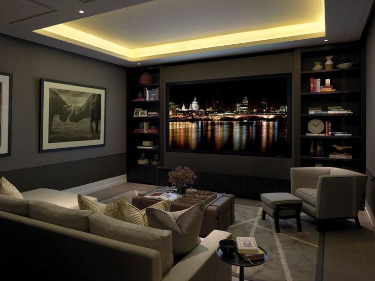 a living room filled with furniture and a flat screen tv mounted to the side of a wall