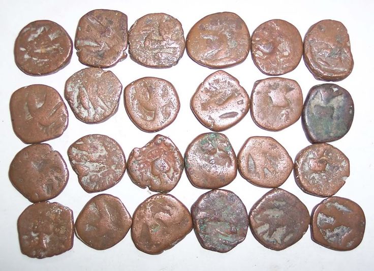 some very pretty old coins on a white table