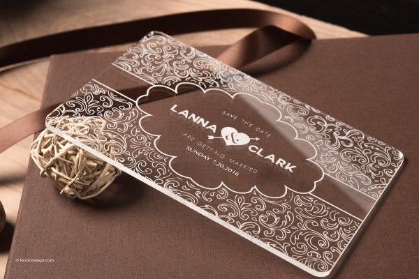 a wedding card with a ribbon tied around it on top of a brown book cover