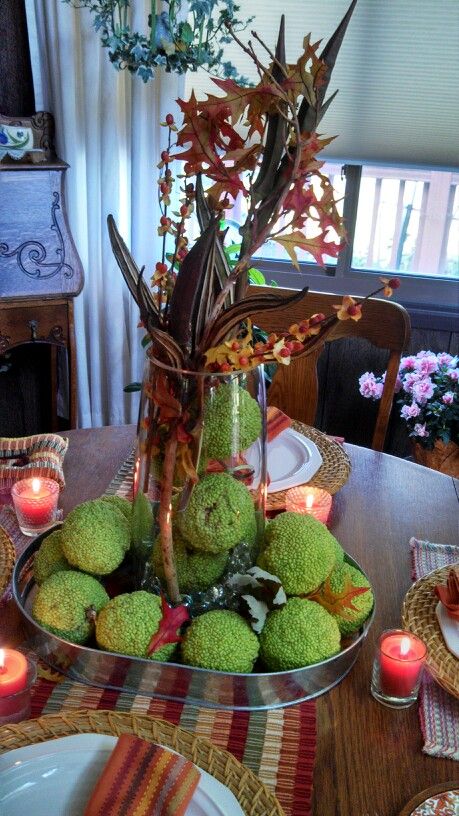 Hedge balls in tray and cylinder glass vase with dried Okra ...