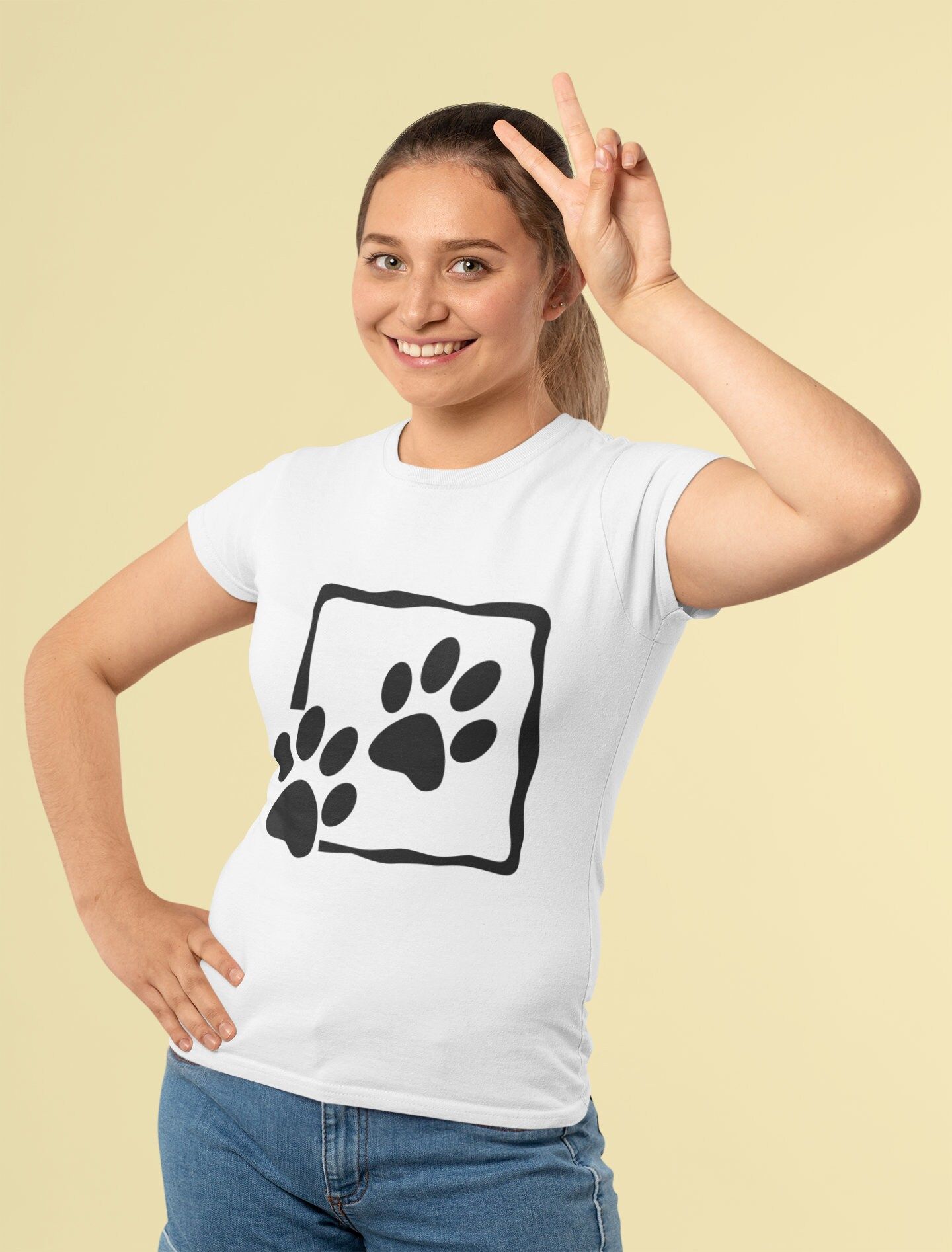 a woman wearing a t - shirt with an animal paw print on it's chest