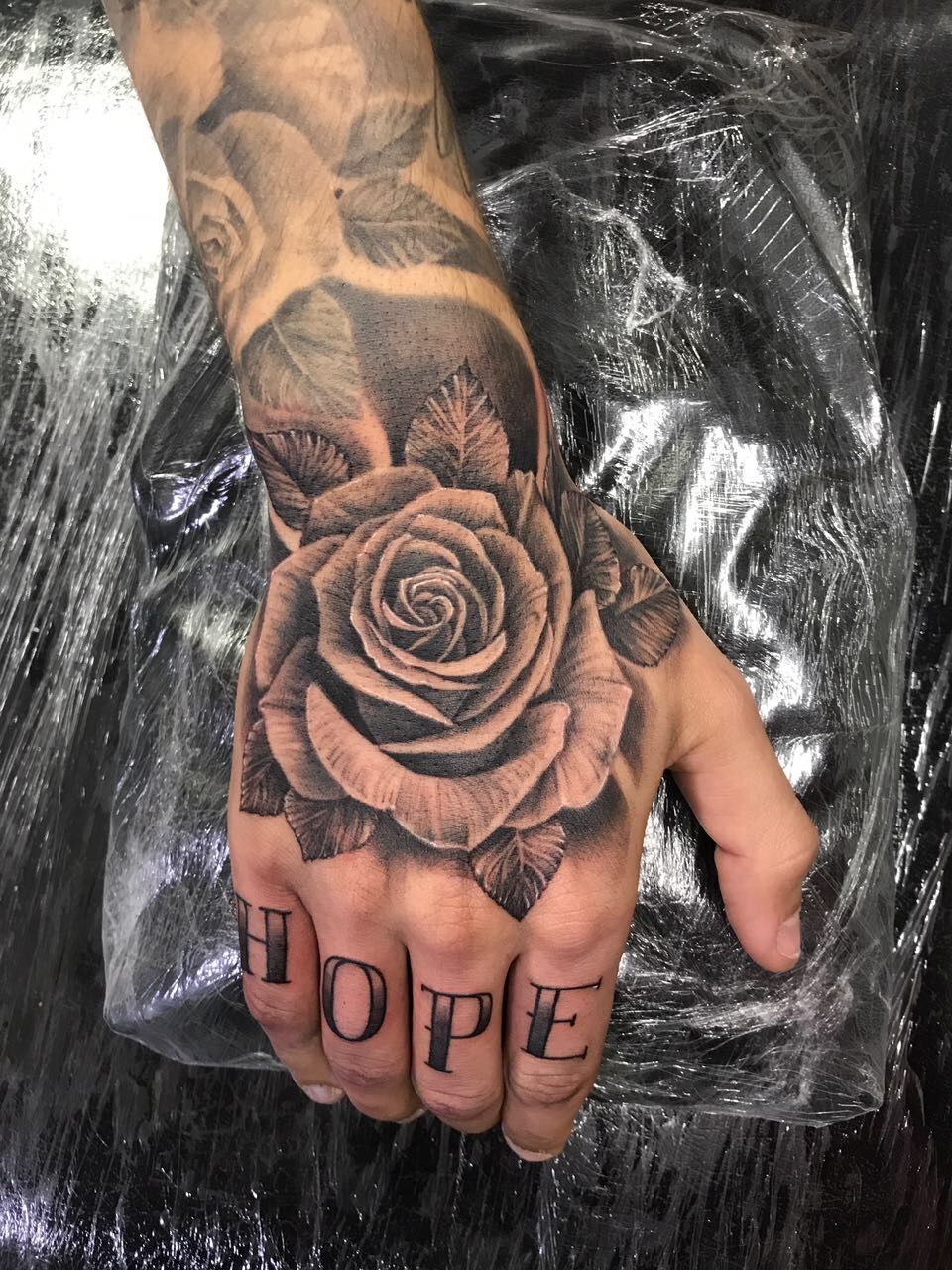 Red And Black Rose Tattoo On Right Hand For Women